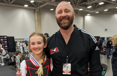 Martial arts student posing after awarding