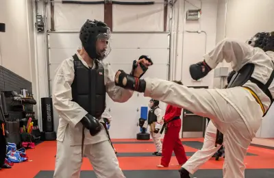 Student practicing kicks during martial arts training