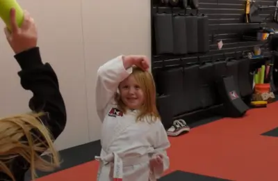 Martial arts student practicing blocking techniques