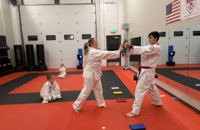 Martial arts student striking training foam