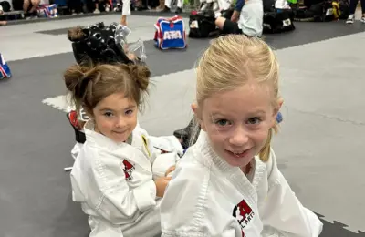 Two students posing while in the gym