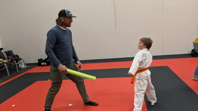 Martial arts student and parent performing poses