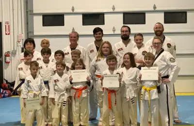 Martial arts students posing with their certificates